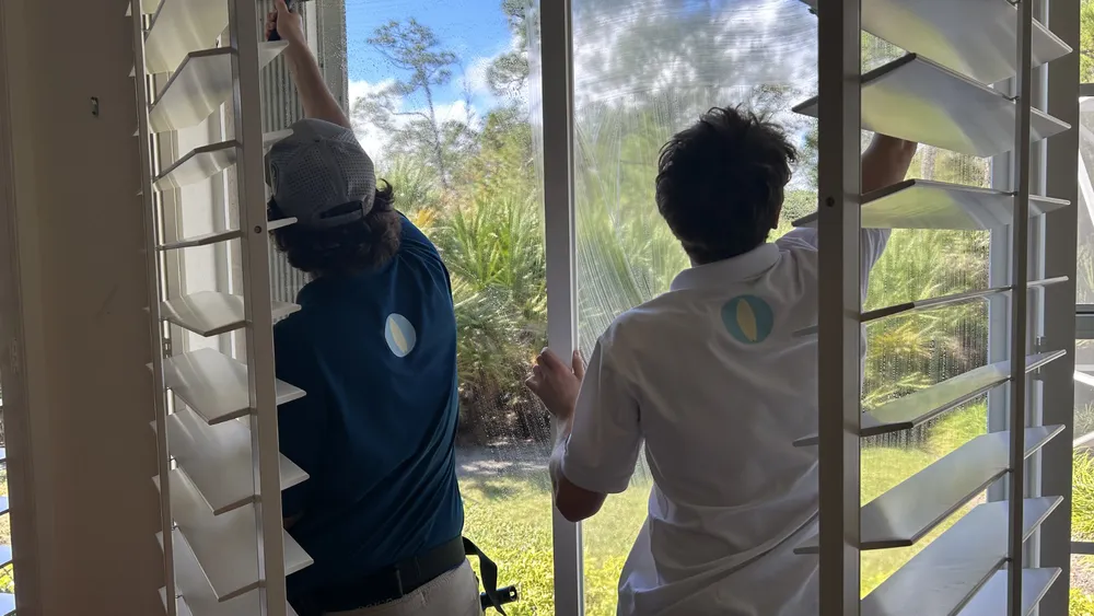 Surf technicians cleaning jalousie windows and screens